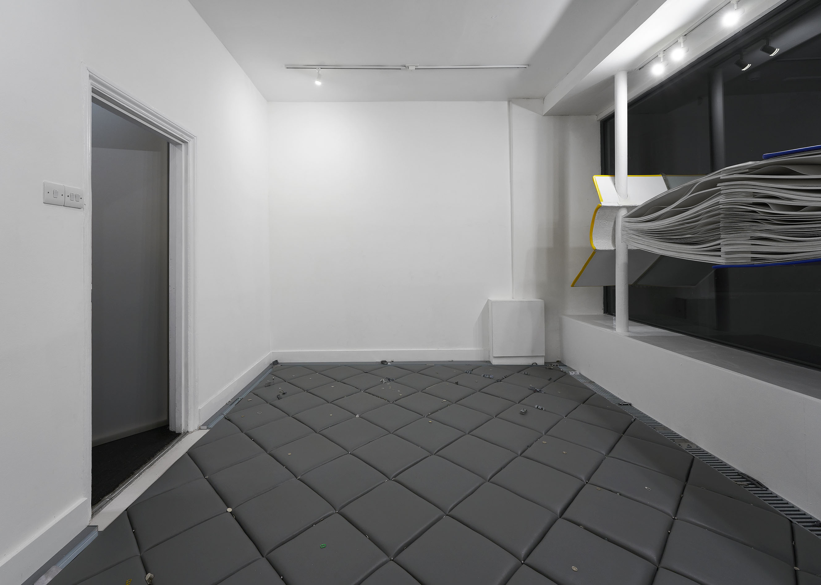 Essentials, Site-specific flooring installation, dimensions variable. Leatherette, plywood, carpet underlay, steel, ring pulls, marbles, money, glitter, keys, whistles, toy cars, personal and found objects. 2024 (AGATA MADEJSKA: 6)